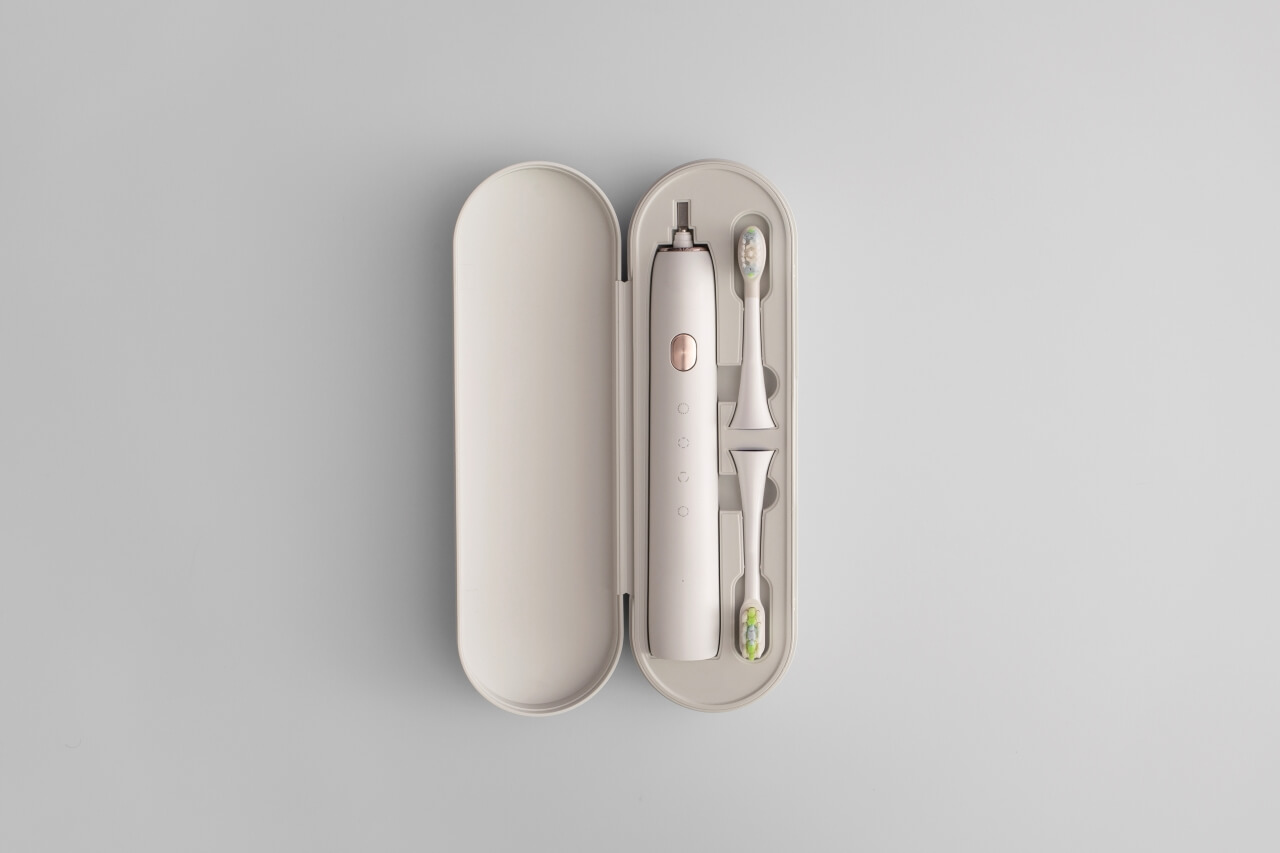 A plastic toothbrush with injection molded elements, serving as an example of injection molding in consumer products